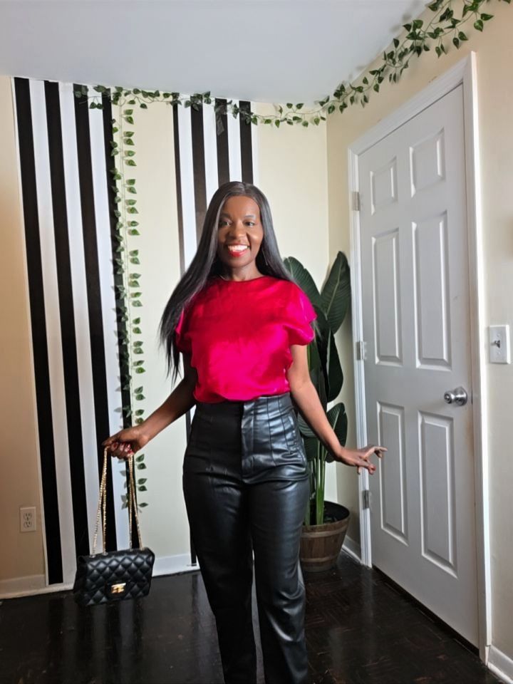 Bold and stylish Valentine’s Day look featuring a hot pink satin blouse, leather pants, and animal print accessories