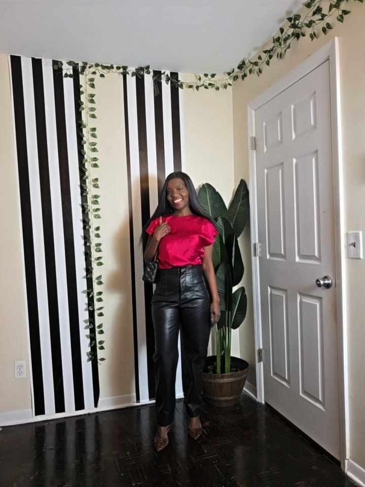 Valentine’s Day outfit with hot pink satin top, leather pants, and animal print pumps